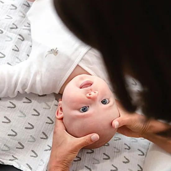 A happy baby being adjusted