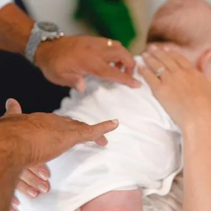 A back adjustment being given to an infant patient