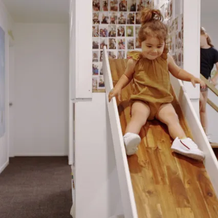 A child playing on the slide in the practice