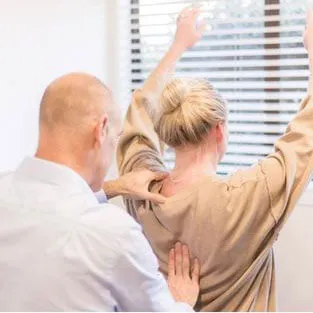 Dr Ash giving a mid-back adjustment