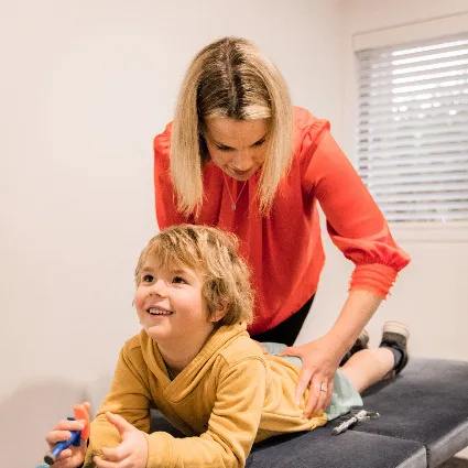 Dr Katie performing a lower-back adjustment on a child patient