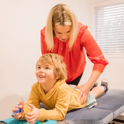 Dr Katie performing a spinal adjustment on a young child