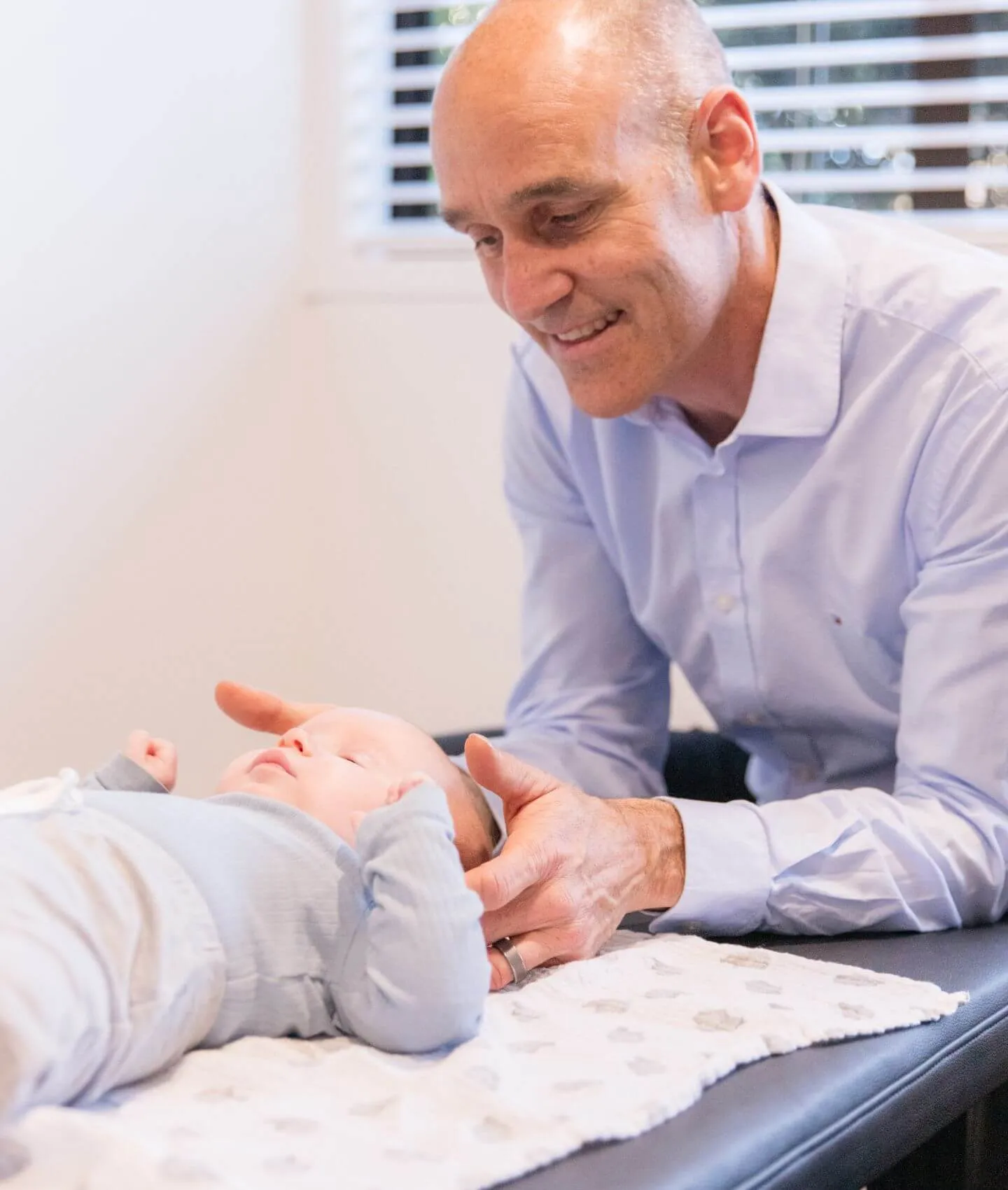 A patient being adjusted face down on the table