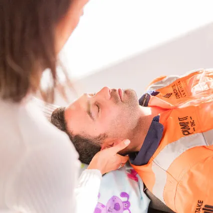 A close-up of gentle neck pressure being applied
